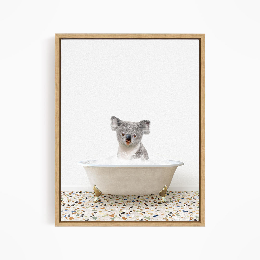 A koala bear sitting in a bathtub filled with water, looking directly at the camera.