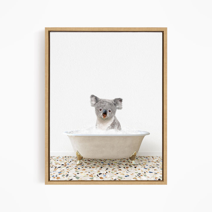 A koala bear sitting in a bathtub filled with water, looking directly at the camera.
