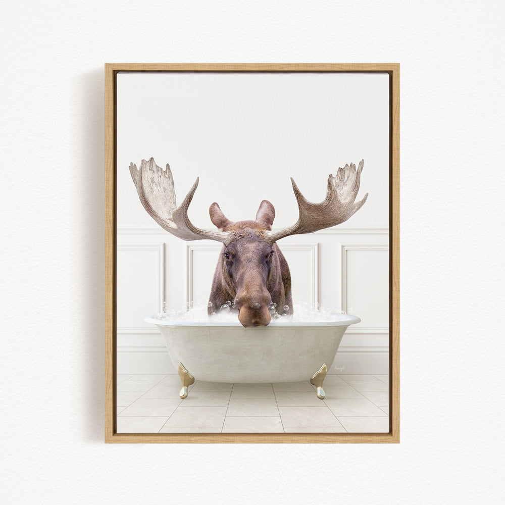A moose with large antlers is sitting in a bathtub filled with water, creating a whimsical and humorous scene.