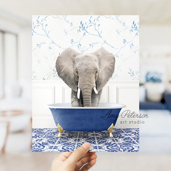 a hand holding a card with an elephant in a bathtub