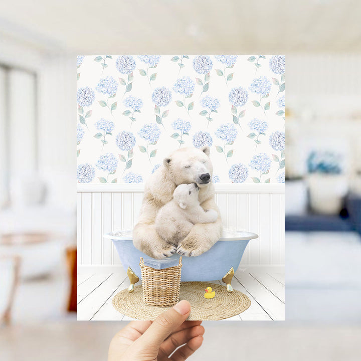 A polar bear is sitting in a bathtub, holding a baby bear, with a blue floral patterned wall behind them.
