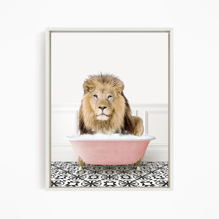 A lion sitting in a pink bathtub filled with bubbles, looking directly at the camera.