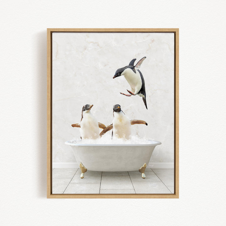 A framed image depicting three penguins in a bathtub, with one penguin flying above the tub.