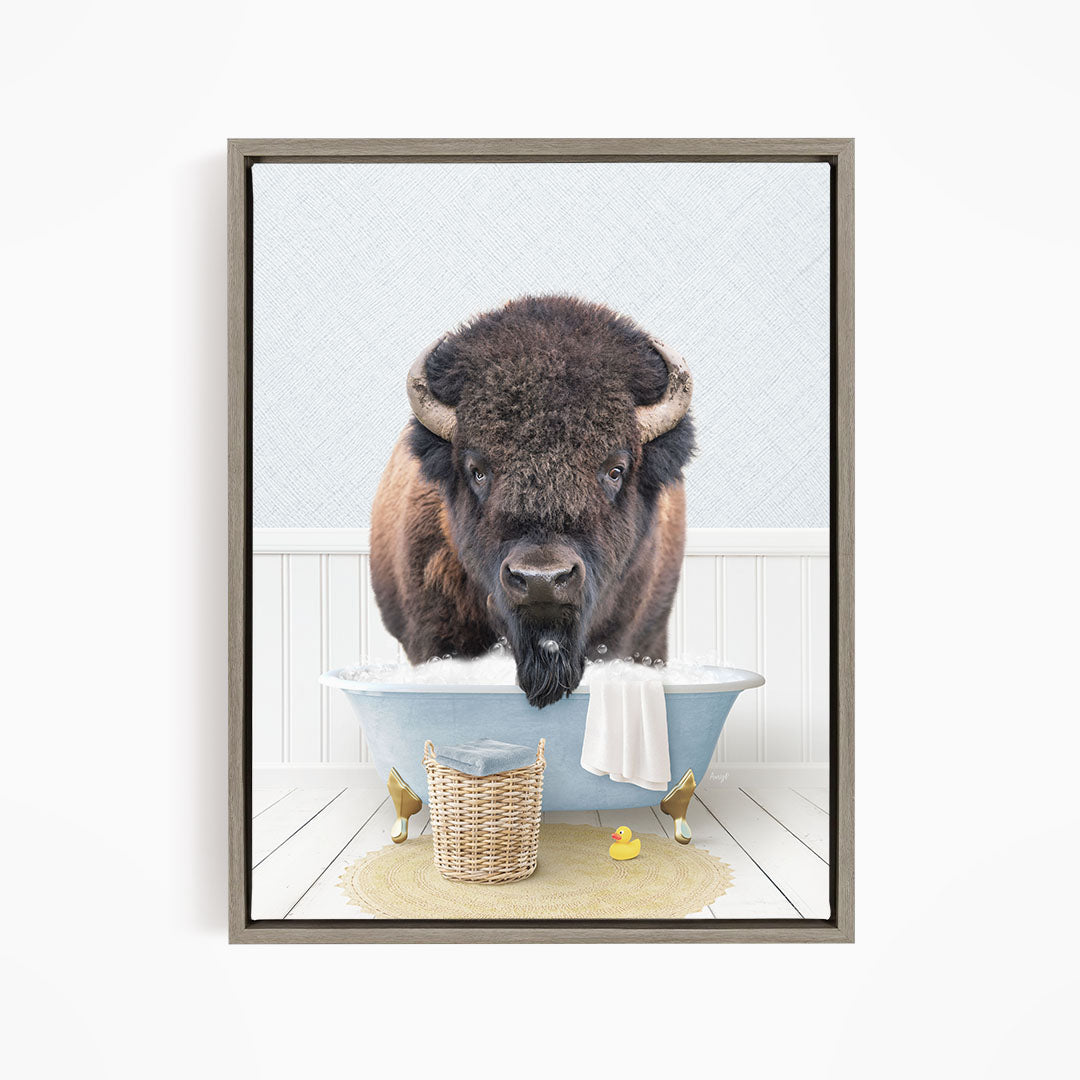 A buffalo standing in a bathtub filled with water, surrounded by rubber ducks and a basket.