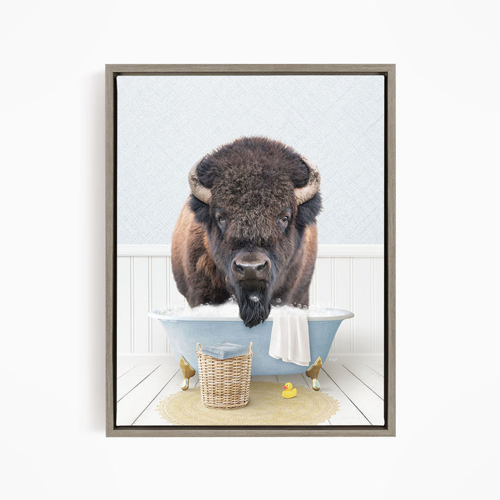 A buffalo standing in a bathtub filled with water, surrounded by rubber ducks and a basket.
