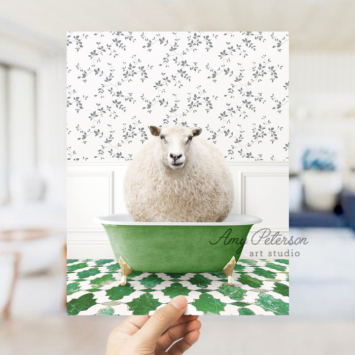 a hand holding a card with a sheep in a bathtub