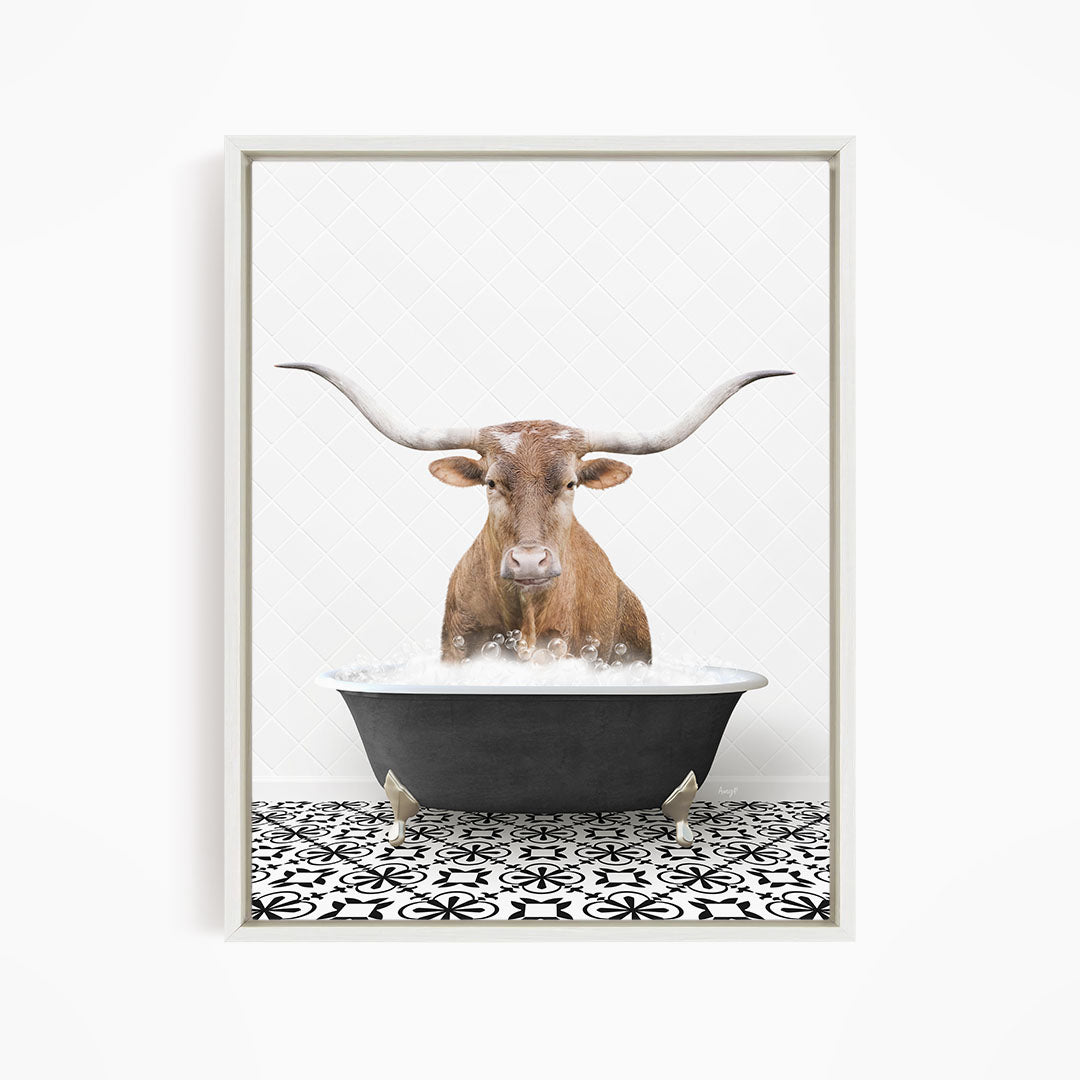 A brown cow with large horns is sitting in a black bathtub filled with water, creating a whimsical and humorous scene.