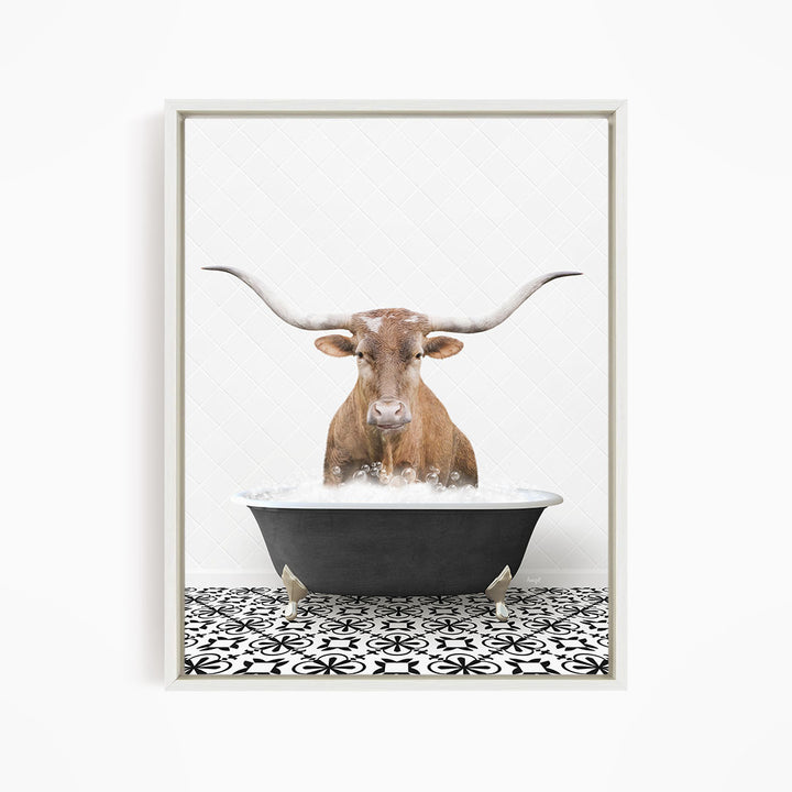 A brown cow with large horns is sitting in a black bathtub filled with water, creating a whimsical and humorous scene.