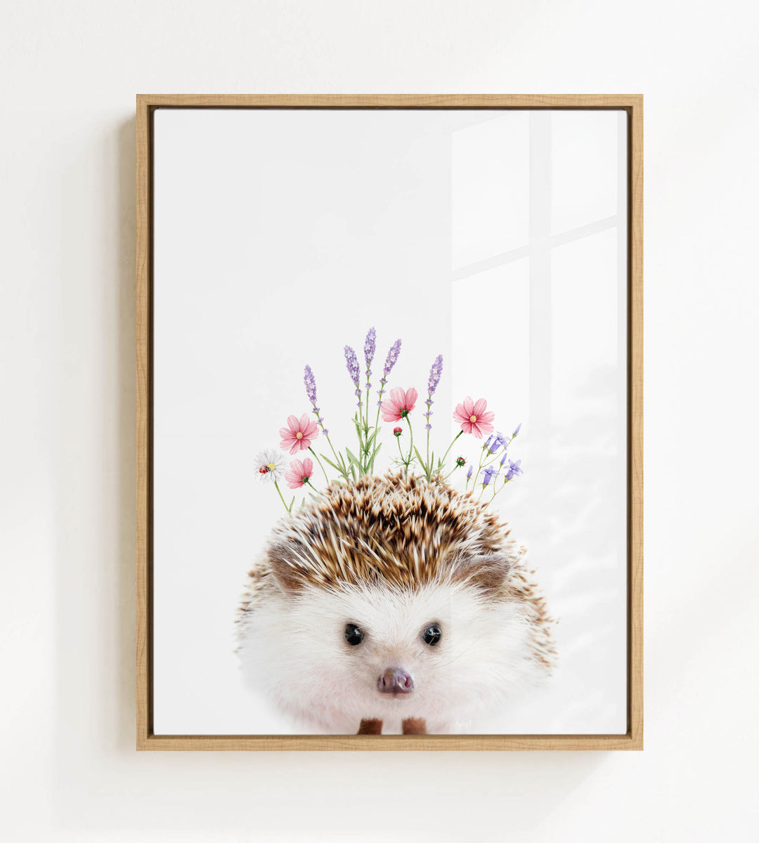 A framed print of a hedgehog with flowers on its head.