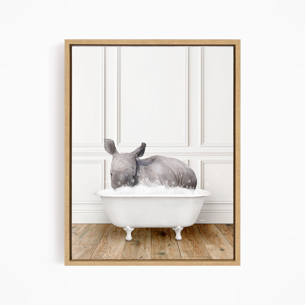A rhinoceros is sitting in a white bathtub filled with water, creating a whimsical and playful scene.