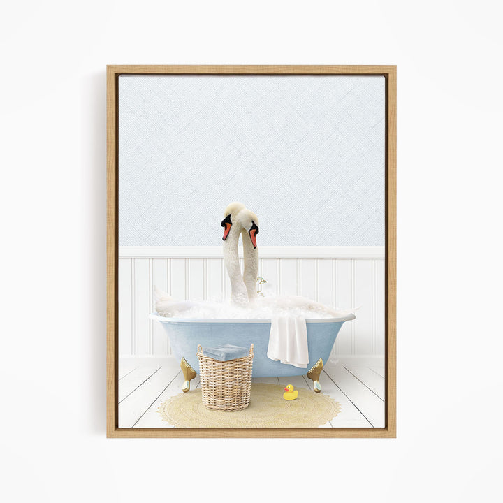 A pair of swans sitting in a blue bathtub filled with bubbles, surrounded by a basket of toys and a yellow rubber duck.