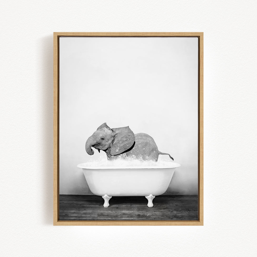 A baby elephant sitting in a white bathtub filled with water, creating a whimsical and playful scene.