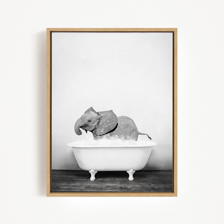 A baby elephant sitting in a white bathtub filled with water, creating a whimsical and playful scene.