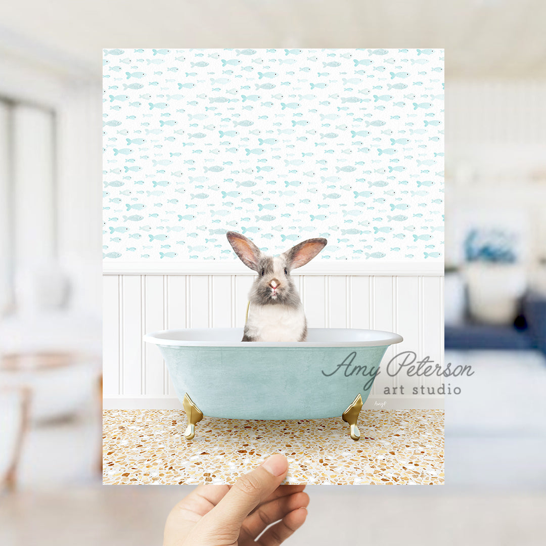 a person holding up a picture of a rabbit in a bathtub