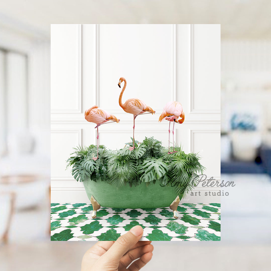 a hand holding a card with three flamingos in a planter