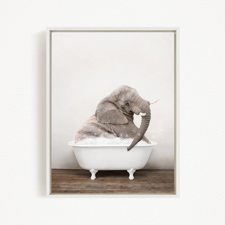 A gray elephant sitting in a white bathtub filled with water, creating a whimsical and playful scene.