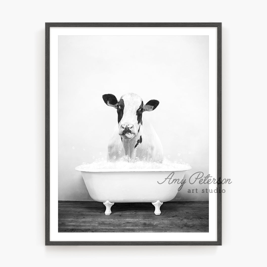 a black and white photo of a cow in a bathtub