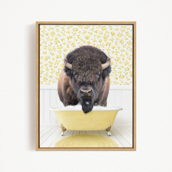 A buffalo with a long beard is sitting in a yellow bathtub, looking directly at the camera.