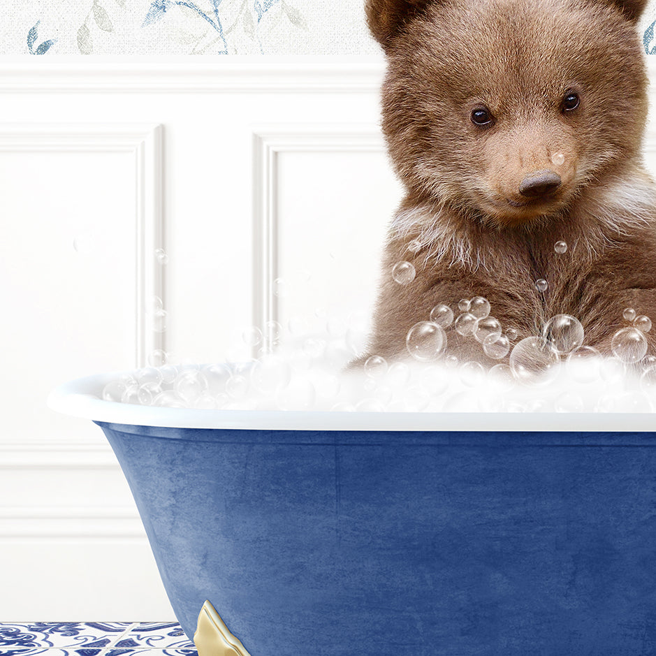 a brown bear sitting in a blue bath tub