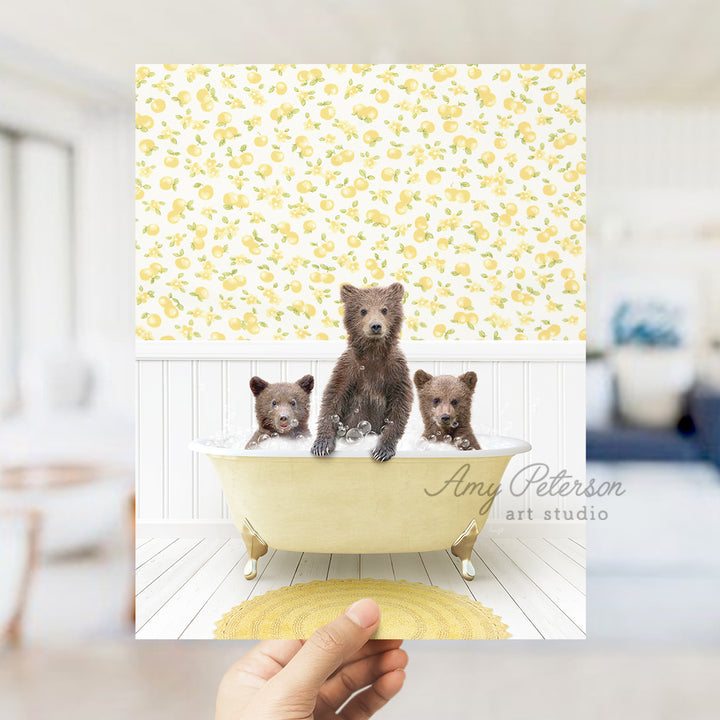 a person holding up a picture of three bears in a bathtub