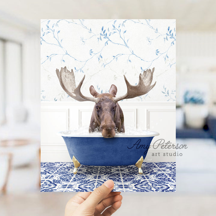 a person holding up a card with a moose in a bathtub