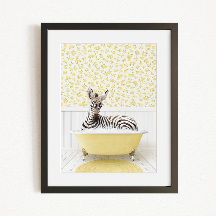 A zebra is sitting in a yellow bathtub, surrounded by a yellow floral wallpaper.