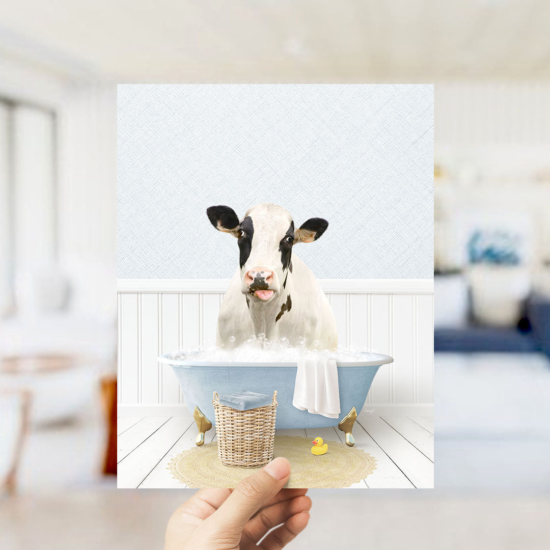 A cow is sitting in a bathtub filled with water, surrounded by a basket and a rubber duck, creating a whimsical and playful scene.