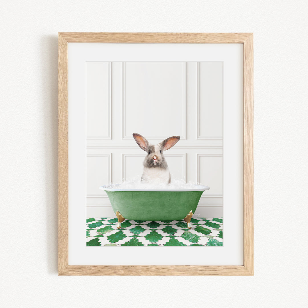 A white rabbit sitting in a green bathtub filled with bubbles, with its head poking out of the tub.