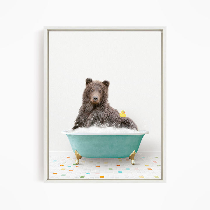 A brown bear sitting in a blue bathtub, with a yellow rubber duck floating in the water.