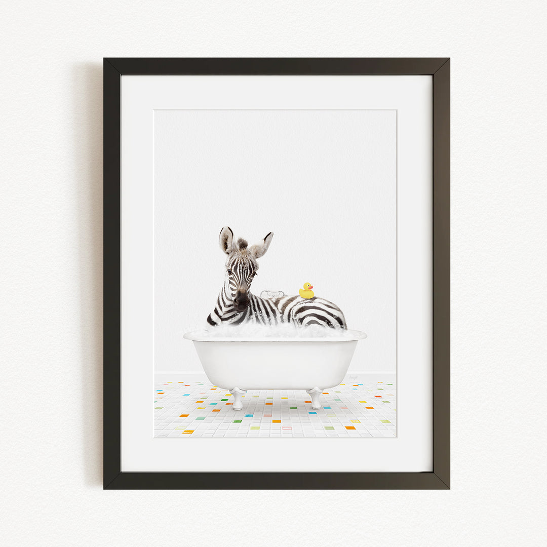 A zebra is sitting in a white bathtub, with a yellow rubber duck resting on its back.
