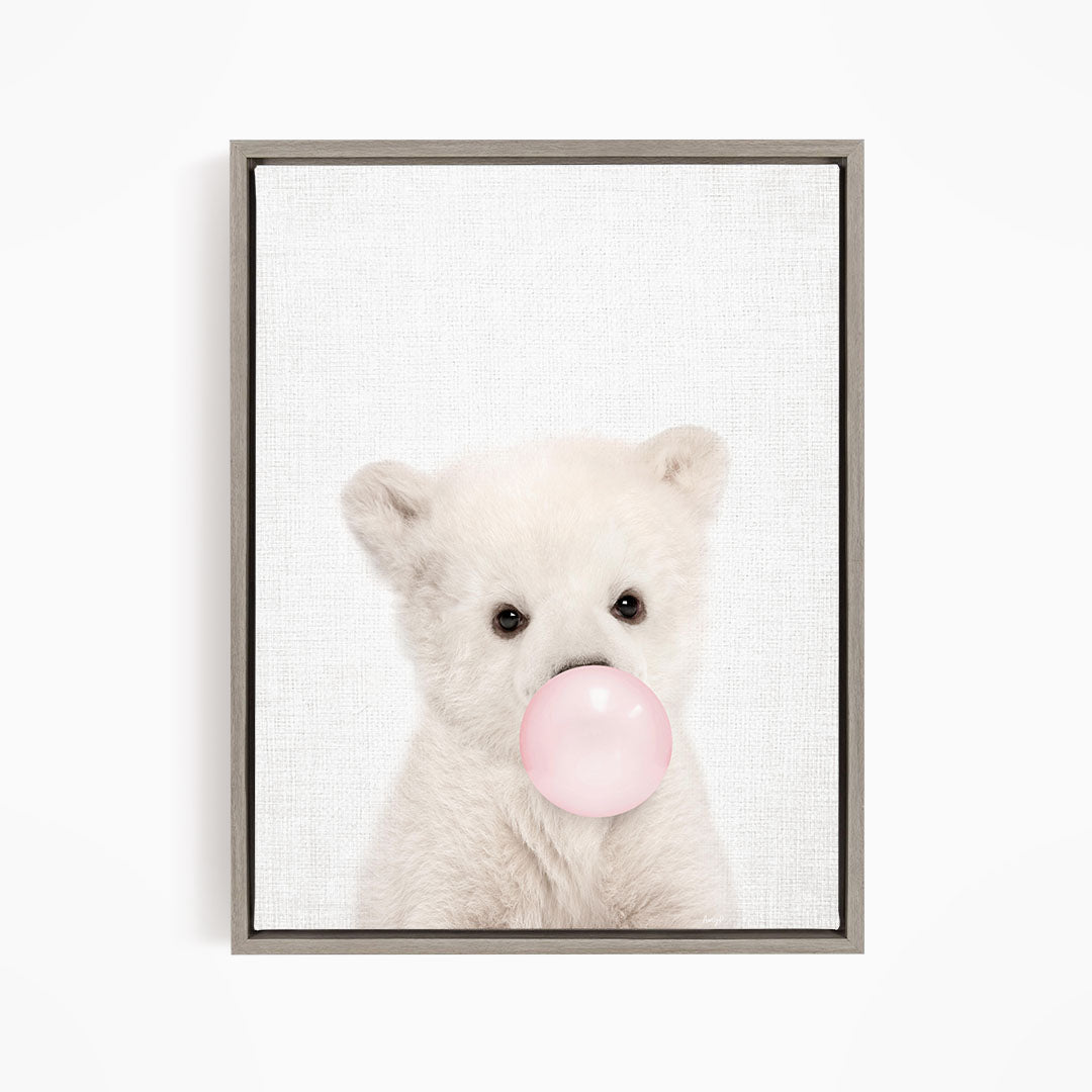 A cute white polar bear is blowing a bubble with a pink bubble gum bubble.