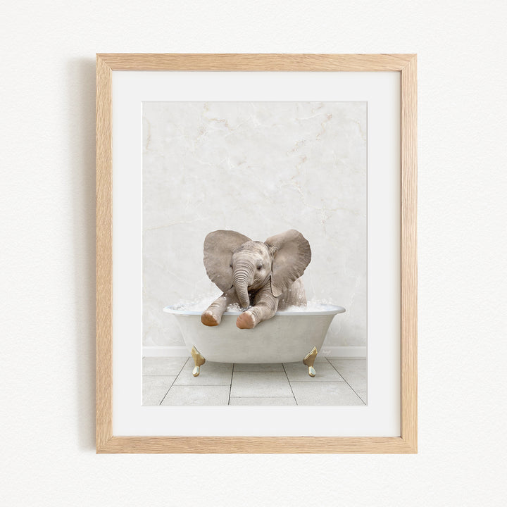 A baby elephant sitting in a white bathtub, with its trunk raised and ears spread out, creating a playful and whimsical scene.