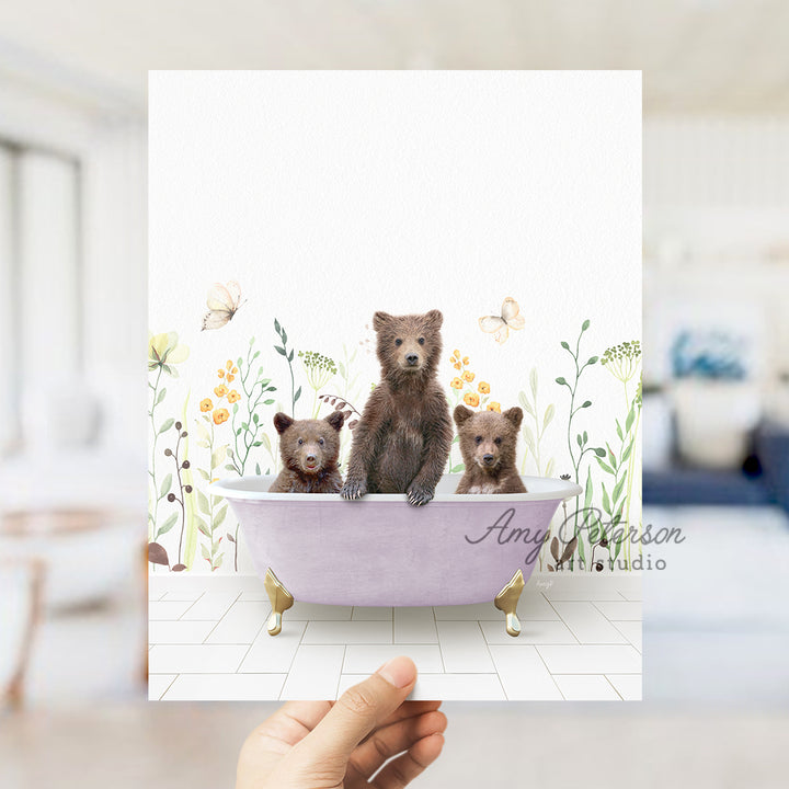 a person holding up a card with three bears in a bathtub