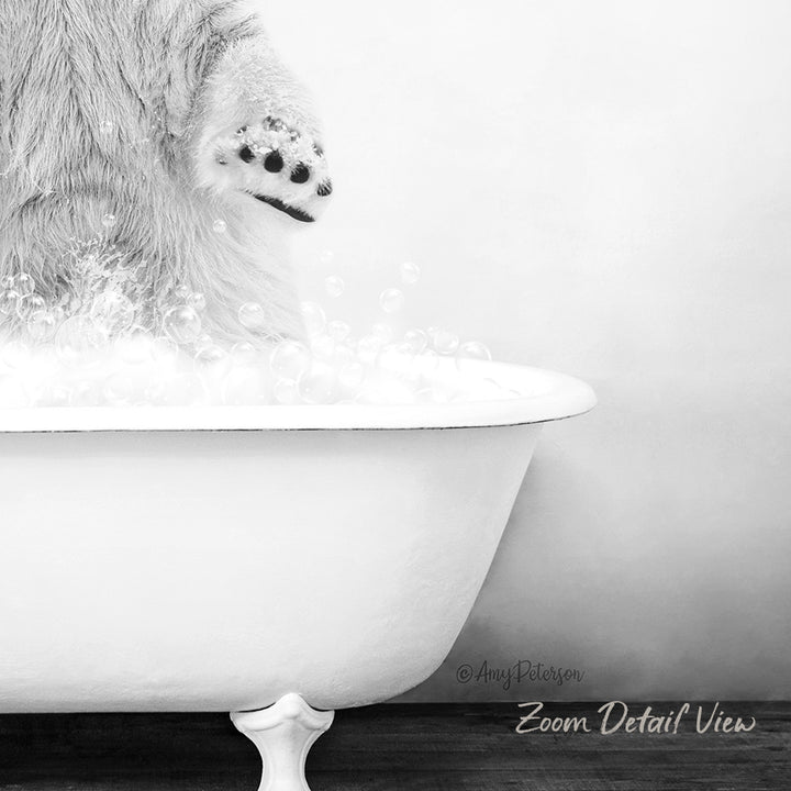 A cat's paw is partially submerged in a white bathtub filled with bubbles, creating a playful and whimsical scene.