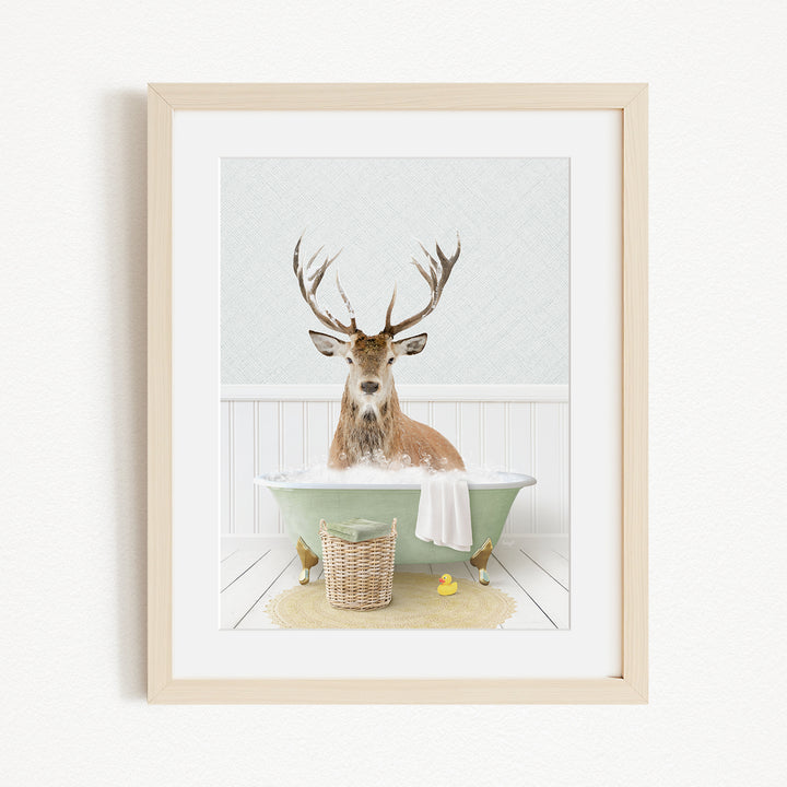 A deer with antlers is sitting in a green bathtub filled with bubbles, surrounded by a basket of rubber ducks and a yellow rubber ducky.