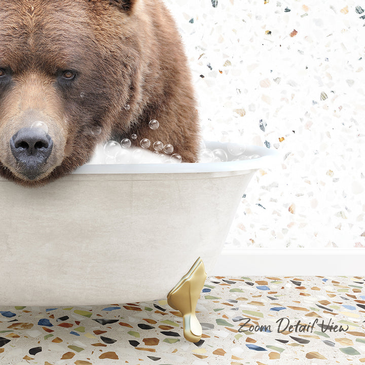 A brown bear is sitting in a white bathtub filled with bubbles, with a mosaic floor in the background.