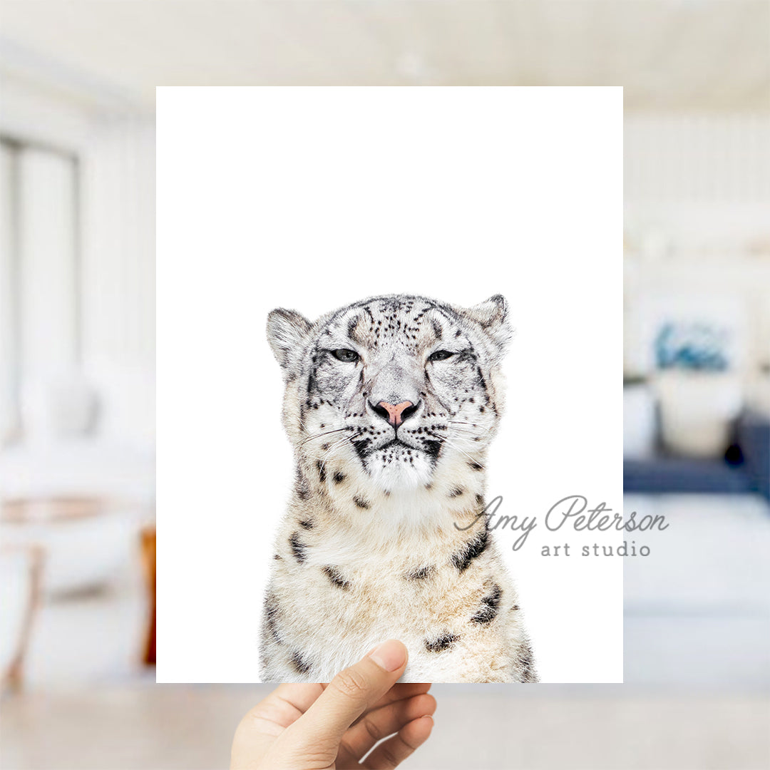 a person holding a card with a picture of a snow leopard