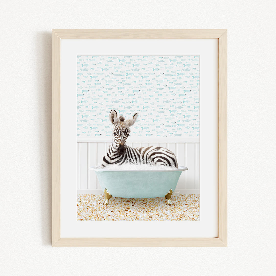 A zebra is sitting in a light blue bathtub, surrounded by a patterned wall and a tiled floor.