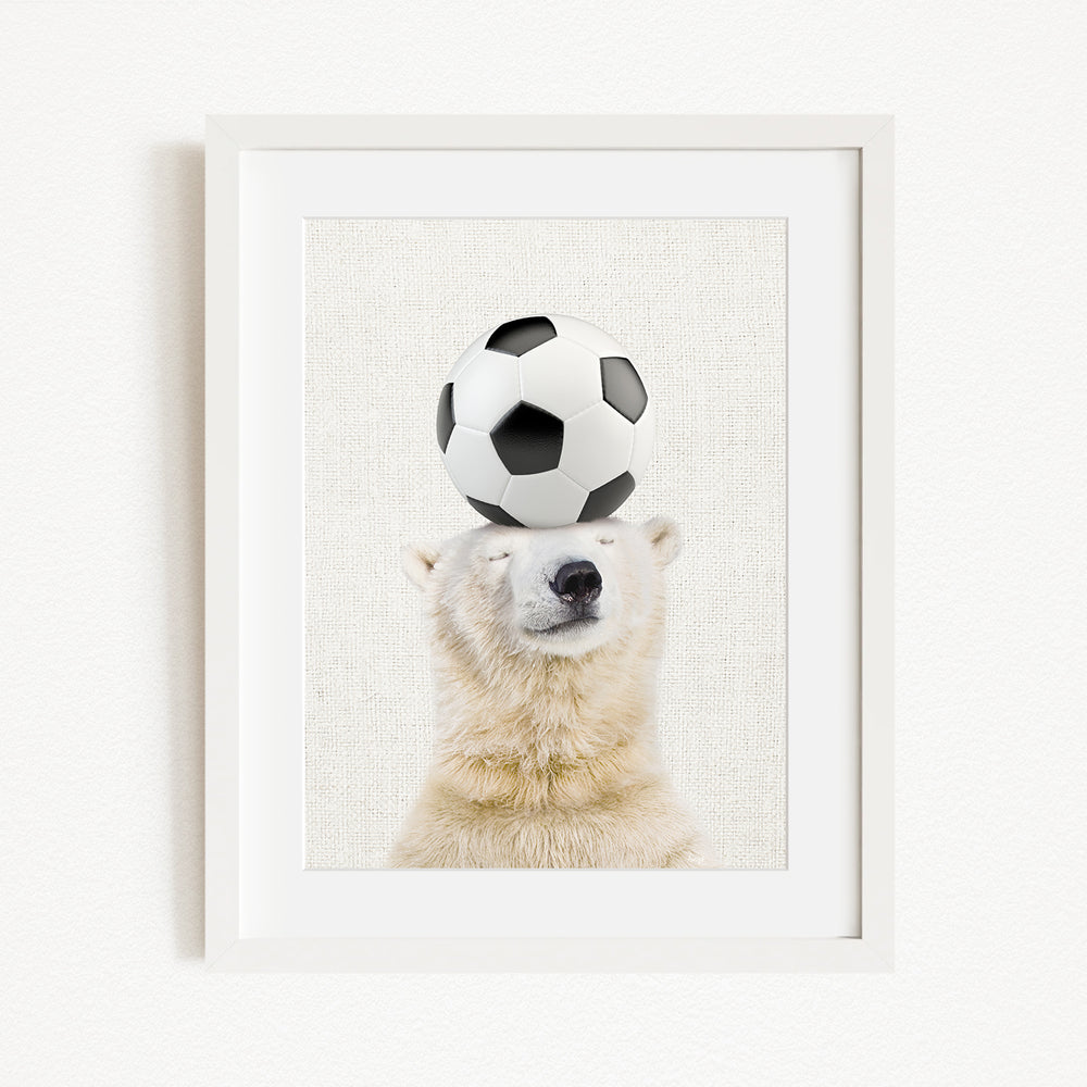 A polar bear balancing a soccer ball on its head.