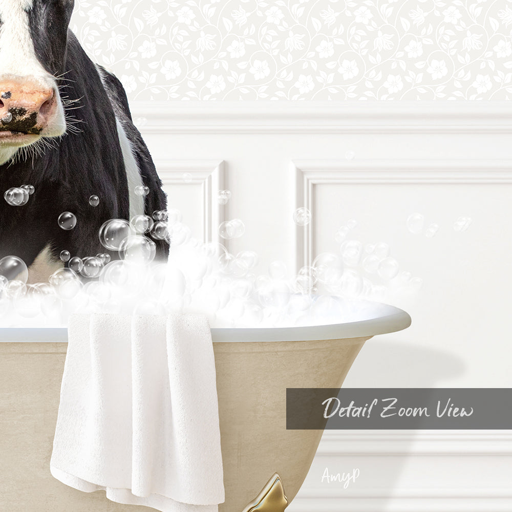 A black and white cow is sitting in a bathtub filled with bubbles, with a towel draped over the side of the tub.