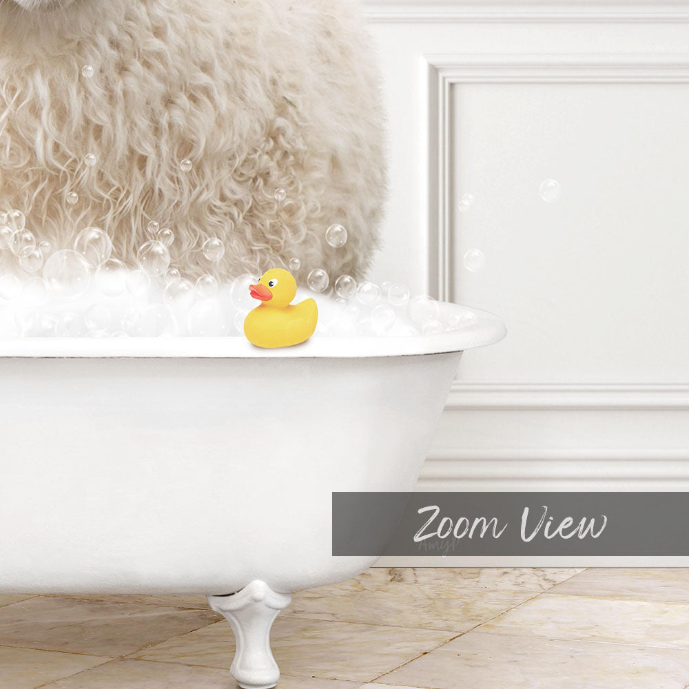 A fluffy white dog is sitting in a white bathtub filled with bubbles, with a yellow rubber duck floating on the water.