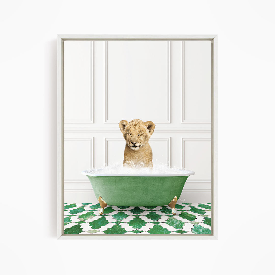 A young lion cub is sitting in a green bathtub filled with water, surrounded by a green and white patterned floor.