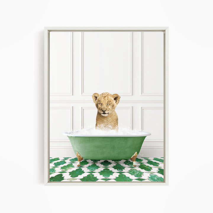 A young lion cub is sitting in a green bathtub filled with water, surrounded by a green and white patterned floor.