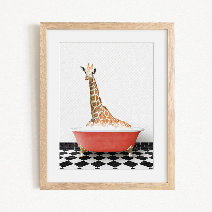 A giraffe sitting in a red bathtub on a black and white checkered floor.