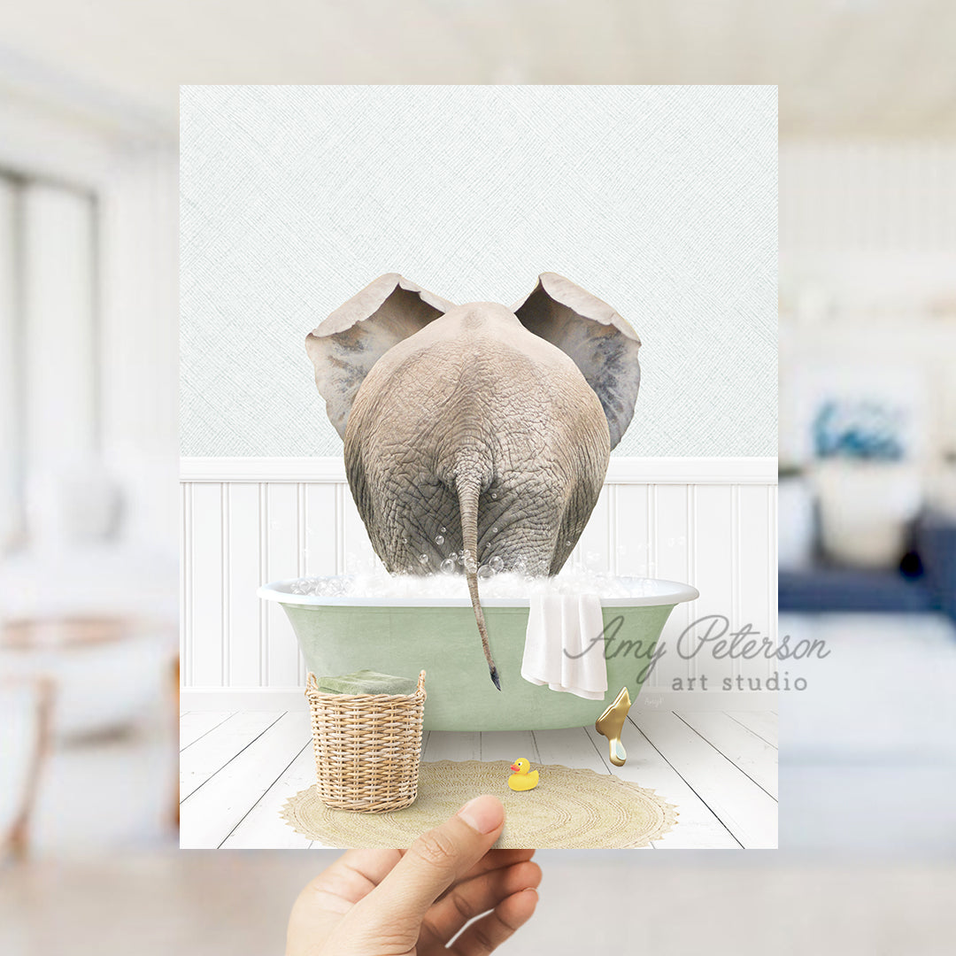 a person holding up a picture of an elephant in a bathtub