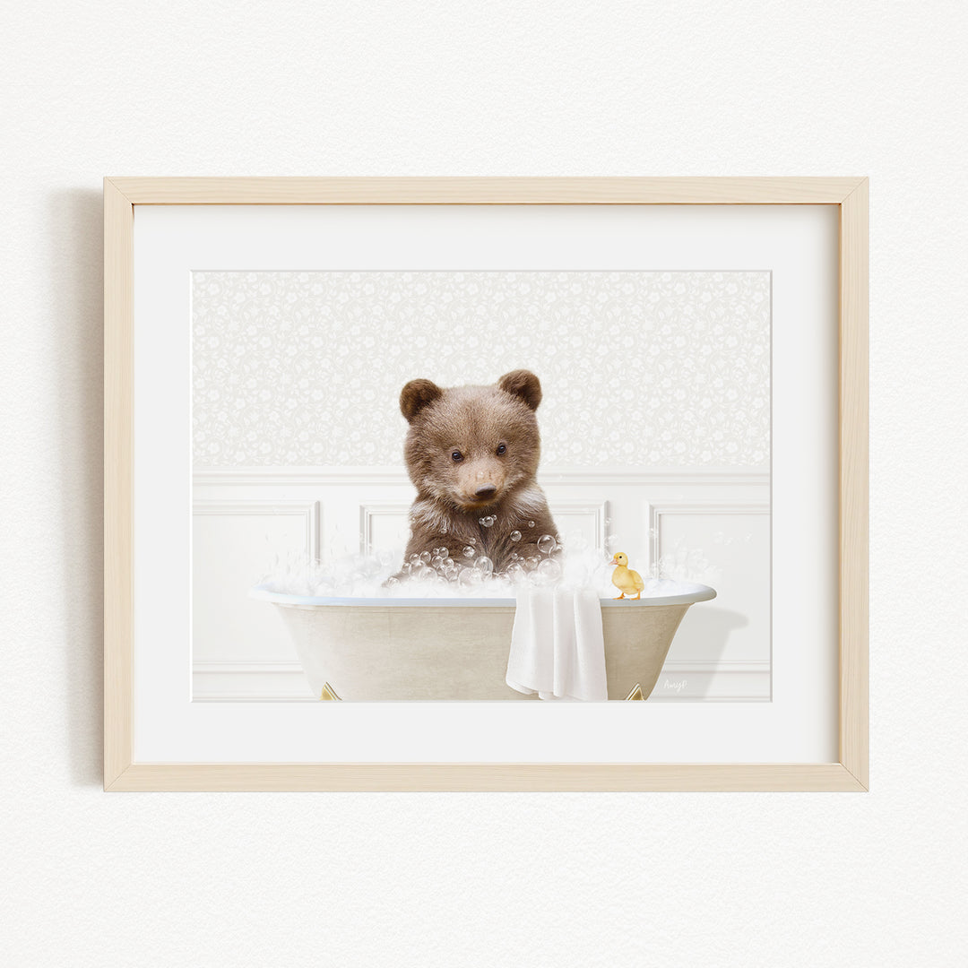 A brown bear sitting in a bathtub filled with bubbles, with a yellow duck floating nearby.
