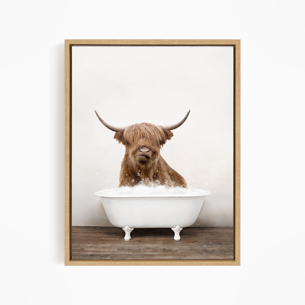 A brown cow with long horns is sitting in a white bathtub filled with water, creating a whimsical and playful scene.