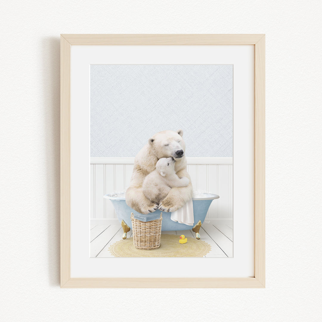 A framed image depicting two polar bears sitting in a bathtub, with one bear appearing to be hugging the other.