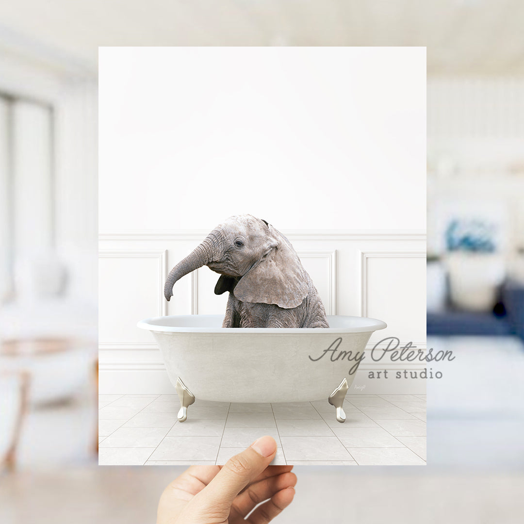 a person holding up a card with an elephant in a bathtub