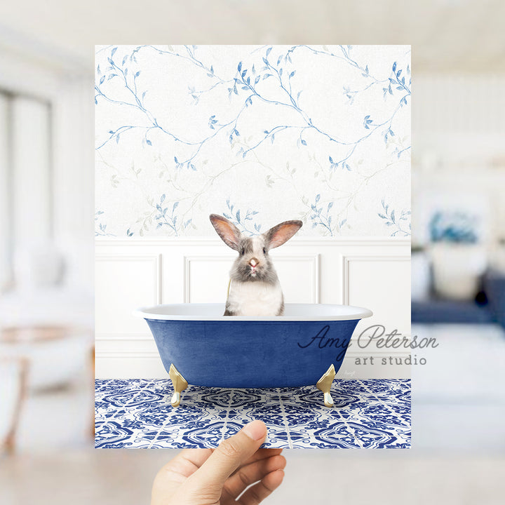 a person holding up a card with a picture of a rabbit in a bathtub